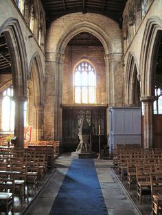 the inside of an old church with wooden pews and blue carpeted flooring