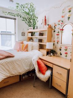 a bed room with a neatly made bed next to a dresser and a plant on the wall