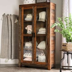 a wooden cabinet filled with lots of blankets