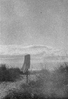 an old black and white photo of a beach chair