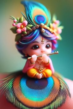 a small figurine is sitting on top of a peacock's tail and holding a flute