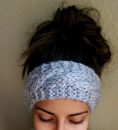 a close up of a woman wearing a knitted headband