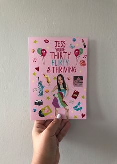 a person holding up a pink book with the title, yes you're thirty and thriving