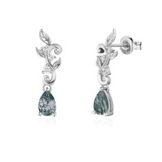 Captivate with every sway of our Leafy Cascades Moss Agate Earrings, where nature's beauty takes center stage. This pair of dangle drop earrings feature an intricate leafy cascade design adorned with sparkling white topaz and the calming beauty of a moss agate gemstone. May this charm elevate your style, casting a spell of irresistible elegance. ✦ 14K White Gold Vermeil (14K white gold plated over a sterling silver base) Unique Silver Moss Agate Jewelry, Elegant Agate Earrings, Silver Moss Agate Jewelry With Cabochon, Cascade Design, Nature-inspired Moss Agate Jewelry With Natural Inclusions, Blue Lace Agate Earrings, Magical Stones, Lucky Stone, Gold Vermeil Jewelry