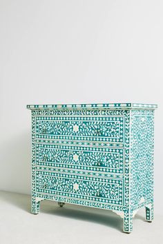 an ornate blue and white chest of drawers