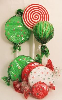 some green and red candy lollipops on a white stick with christmas decorations