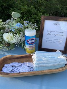 a wooden tray filled with lots of blue and white buttons next to a sign that says cloroy