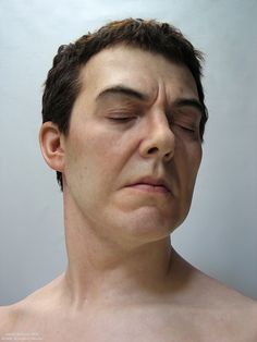 a man with his eyes closed is shown in this image, he has no shirt on