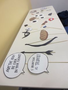 a white table topped with paper cutouts and speech bubbles