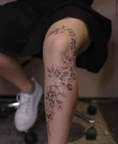 a woman's leg with flowers on it