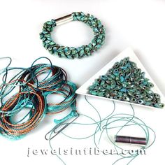 several bracelets and beads are laid out on a table