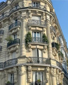 an ornate building with balconies and flowers on the balconys in paris, france