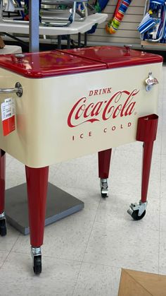 an old coca - cola cooler is on display in a store