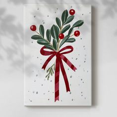 a christmas card with holly and berries tied in a red ribbon on a white background