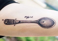 a spoon tattoo on the arm that says figi and has an arrow in it