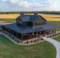 an aerial view of a large house in the middle of a field