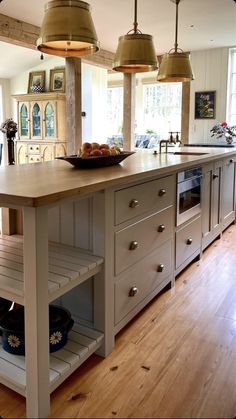 a kitchen island with two hanging lights above it