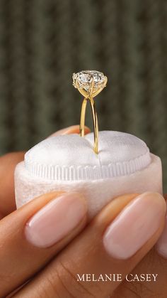 a close up of a person holding a ring