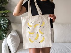 Bananas Tote Bag Aesthetic Canvas Tote Bag Plant Tote Reusable Shopping Bag Market Bag Cute Tote Bag Banana Bag Cottagecore Tote Modern Minimalist Boho Simple Southern Grocery Bag Produce Bag Gift for her Gift for him ★ Care Instructions Empty the bag before washing. We suggest using stain remover on any visible stains. Machine washing is not recommended. Wash in cold water by hand. Hang dry is necessary before high-temperature ironing ★ Production & Shipping Processing typically takes 1-3 days. Depending on where you live, shipping takes 2-5 days. You will receive a tracking number once your order has shipped. We do not accept returns or exchanges, as all items are made to order. Delays with USPS may cause your package to arrive later than expected. If you experience any issues with this Tote Aesthetic, Cartoon Banana, Aesthetic Bag, Aesthetic Canvas, Banana Bag, Produce Bags, Bags Aesthetic, Cute Tote Bags, Bag Cute