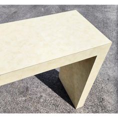 a white table sitting on top of a cement floor