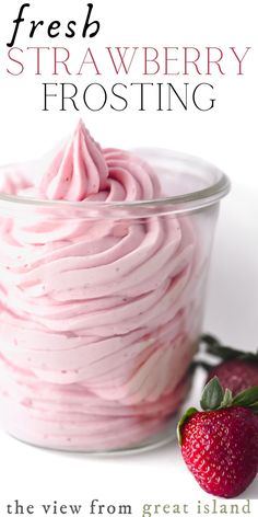 strawberry frosting in a glass bowl next to a strawberry