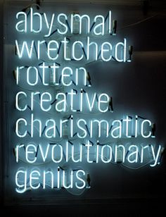 a neon sign that reads, abysssmal werched rotten creative charismic revolution genius