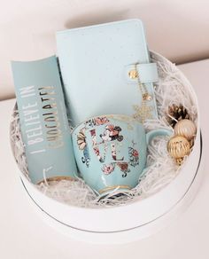 a tea cup and some books in a box