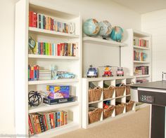 there are many bookshelves in the room with toy cars on top of them