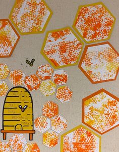 an art project with orange and white hexagonals on the ground, including one beehive