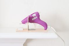 DIY a hot glue gun holder in an easy way! In this post, I'm sharing how to make this hot glue stand in a few simple steps. No fancy tools or skills are required. All you need is some spare wooden board, and a few common tools and spare parts. Large Scale Wall Art, Diy Glue, Gorilla Glue, Favorite Paint Colors, Favorite Paint, Super Glue, Glue Gun, Hot Glue Gun, Wooden Board