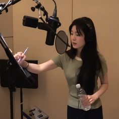 a woman standing in front of a microphone