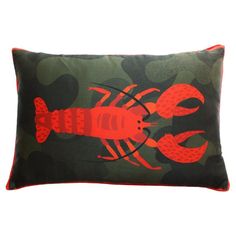 a red lobster on green camo print pillow with orange piping in the center