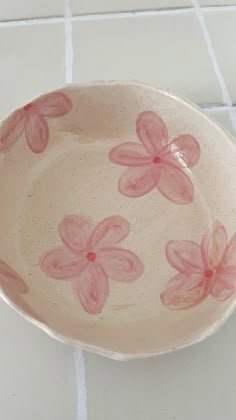 a bowl with pink flowers painted on it