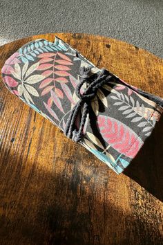 a small pouch sitting on top of a wooden table