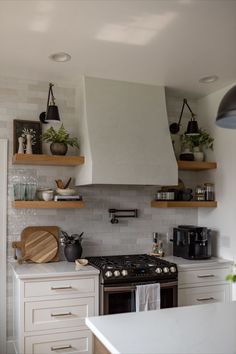 a stove top oven sitting inside of a kitchen