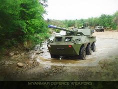 an army vehicle driving through a muddy road