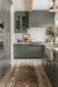 a kitchen with gray cabinets and an area rug