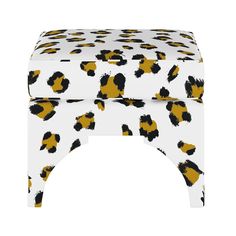 an animal print stool with yellow and black spots on the top, against a white background