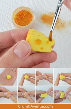 there is a hand holding a yellow piece of cheese