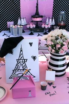 a pink table with black and white decorations