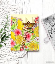 a card with some flowers on it next to a lace doily