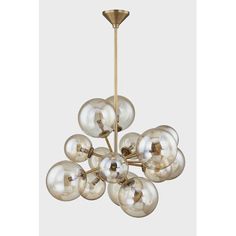 an antique brass chandelier with clear glass globes hanging from the ceiling,