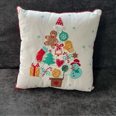 a christmas tree pillow on a couch