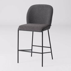 an upholstered stool with black frame and grey fabric seat, viewed from the front