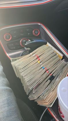 a bunch of papers sitting in the center console of a car