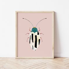 a framed photograph of a bug on a pink background