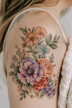 a woman's shoulder with flowers painted on it