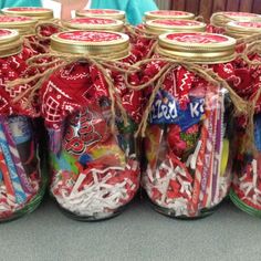 several jars filled with candy sitting on top of a table