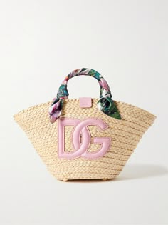 Dolce & Gabbana's 'Kendra' tote is part of the label's 'Flower Power' collection. It's woven from raffia and detailed with a large leather logo, plus floral-print silk-twill wrapped like a scarf around the handles. The joyful design makes it the perfect choice for summer and you'll have plenty of space for your essentials - think phone, wallet and your current book. Spring Bags 2024, Joyful Design, Summer Purse, Luxury Tote Bags, Silk Twill, Leather Logo, Phone Wallet, Bags Designer Fashion, Charlotte Tilbury