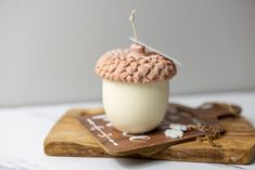 a crocheted cupcake sitting on top of a cutting board